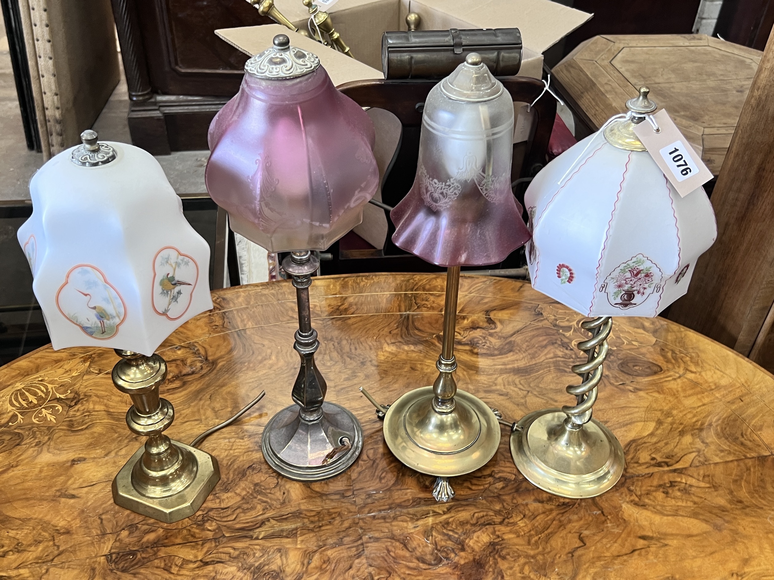 Two Edwardian silver plated and brass table lamps with etched cranberry shades and two converted candlestick lamps, tallest 50cm